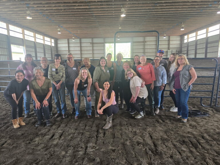 A group of people posing for a photo in an indoor arena
