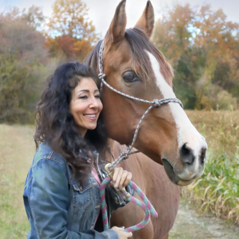 a woman next to a horse