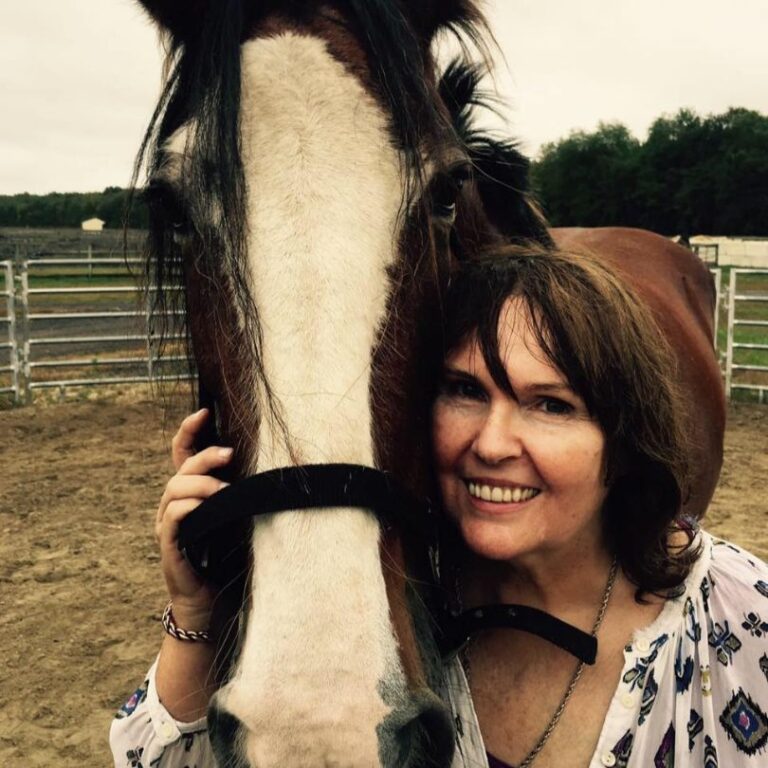 a woman next to a horse